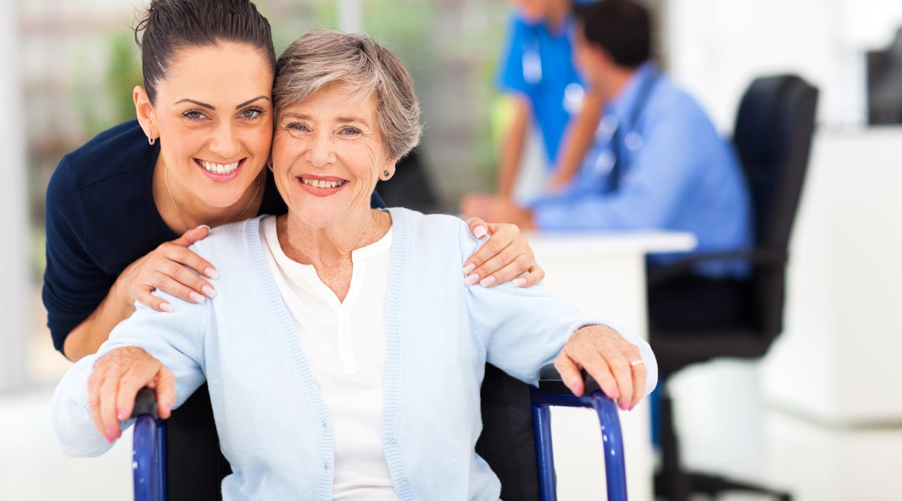 caring adult daughter accompanying senior mother visiting doctor